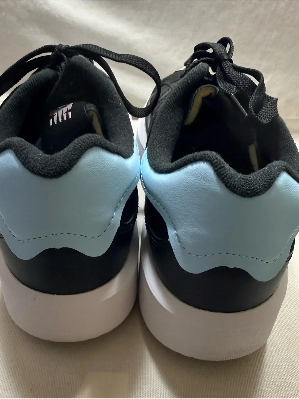 New Balance - Black and White Women's Leather Sneakers with Light Blue Accent